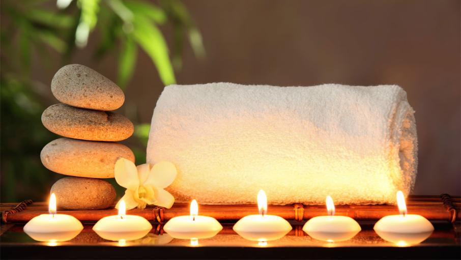 an image of relax in the rec spa with stones, towel and candels