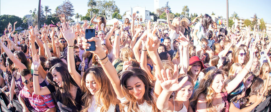Students holding their hands up at a concert outside on LMU campus