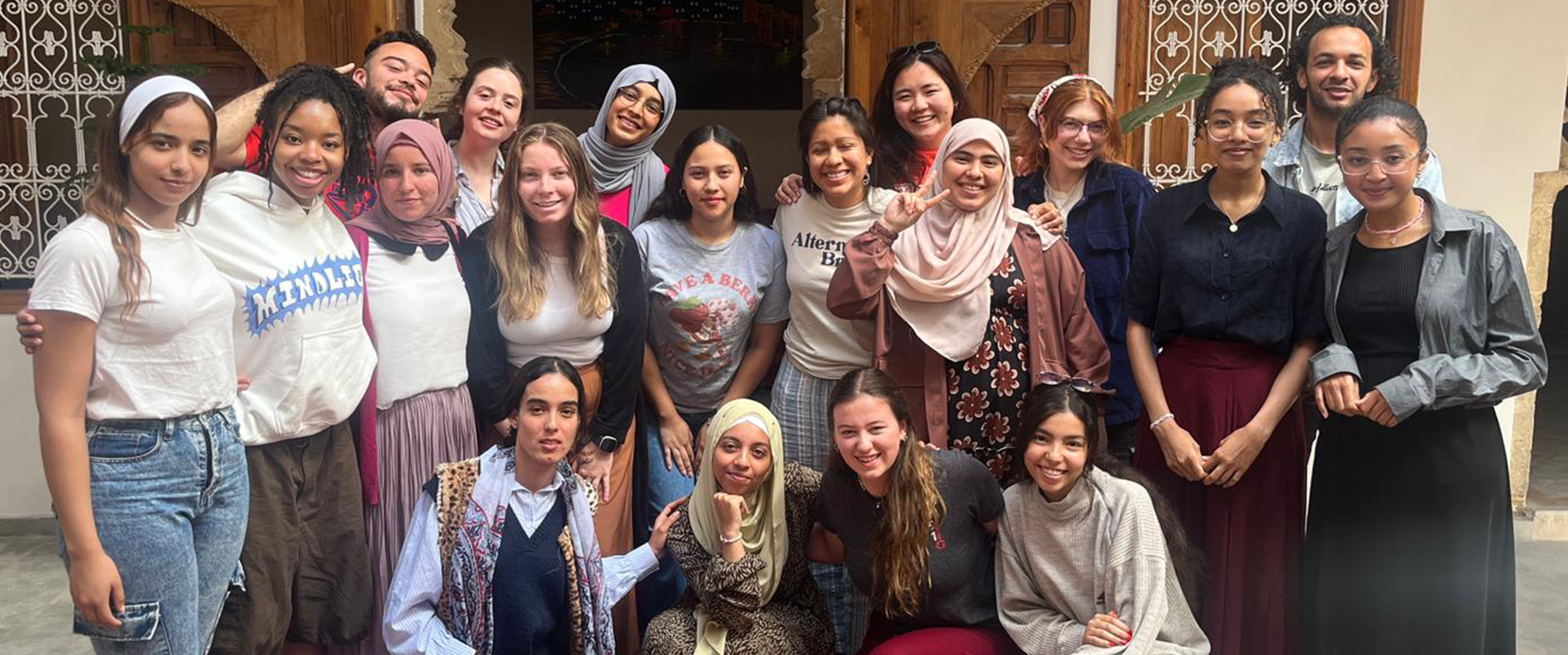 A group of LMU students and locals posing in Morocco on a summer Alternative Break immersion.