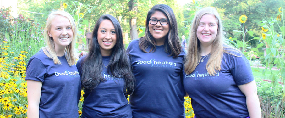 A picture of four volunteers wearing Good Shepherd shirts