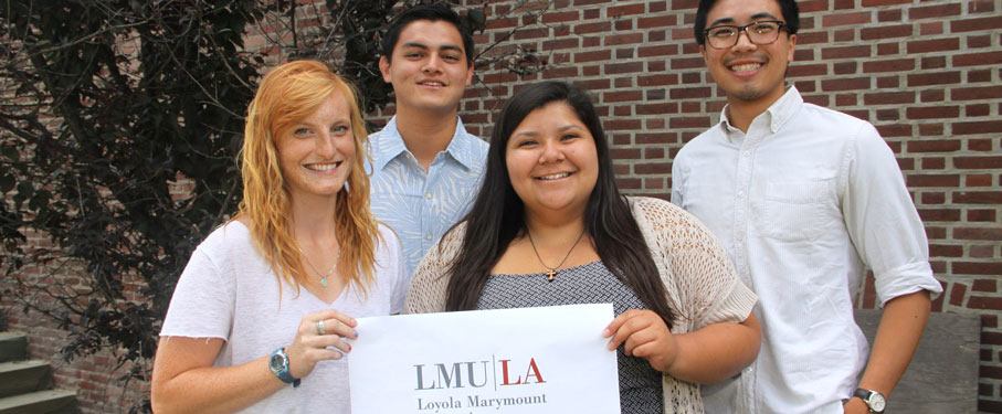 A picture of post-grad volunteers holding an LMU sign