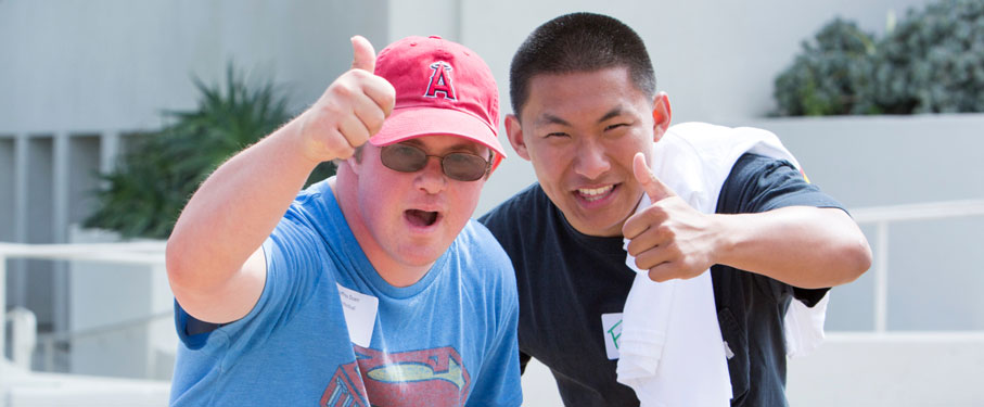 a special games volunteer and participant giving a thumbs up to the camera