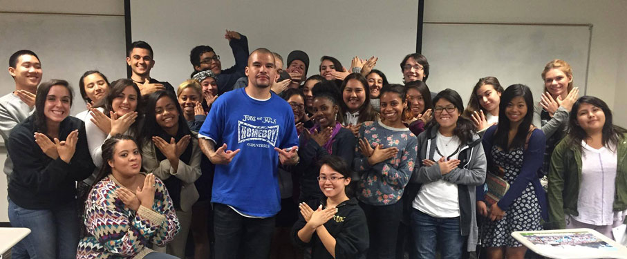 A group of LMU students posing with a member of Homeboy Industries.
