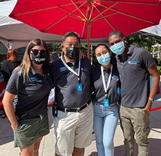 Student Affairs staff in masks standing outside during campus move-in day.