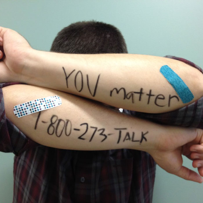You Matter- National Suicide Hotline (800) 273-TALK writing on a man's arm