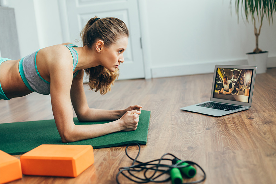 Female doing yoga watching a virtual class