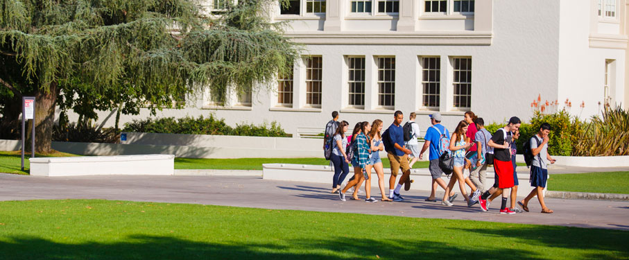 Students walking around campus near Malone Student Center