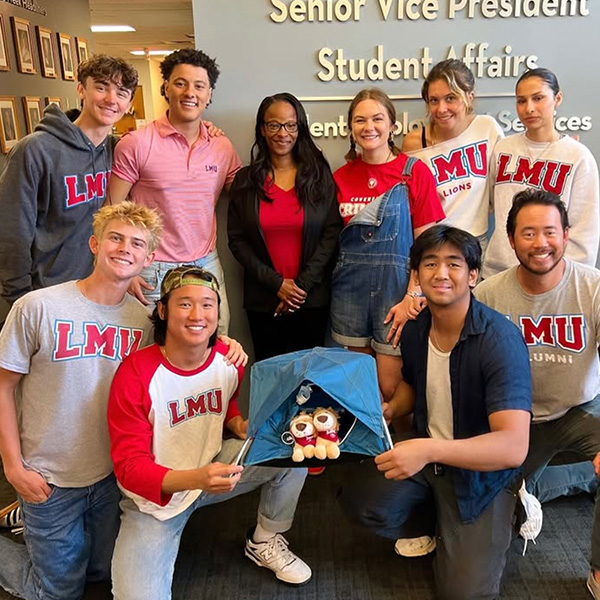 A group of students and staff pose inside the Senior Vice President for Student Affairs office.