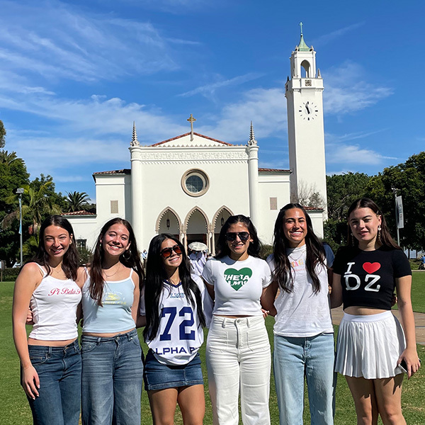 Female students in Panhellenic Council pose inside Burns Back Court for a photo.