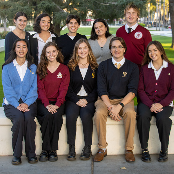 A group of service organization presidents pose outside in their designated sweaters.