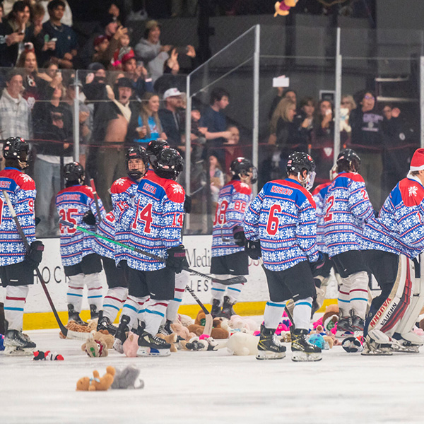 Club Ice Hockey members collect teddy bears and stuffed animals on the ice during the annual Teddy Bear Toss.