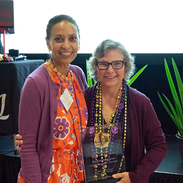 Two staff members stand together after an awards ceremony during the JASPA Five-Year Institute in 2025.