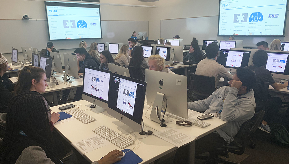 Students in a computer lab looking at a training program for LEO.