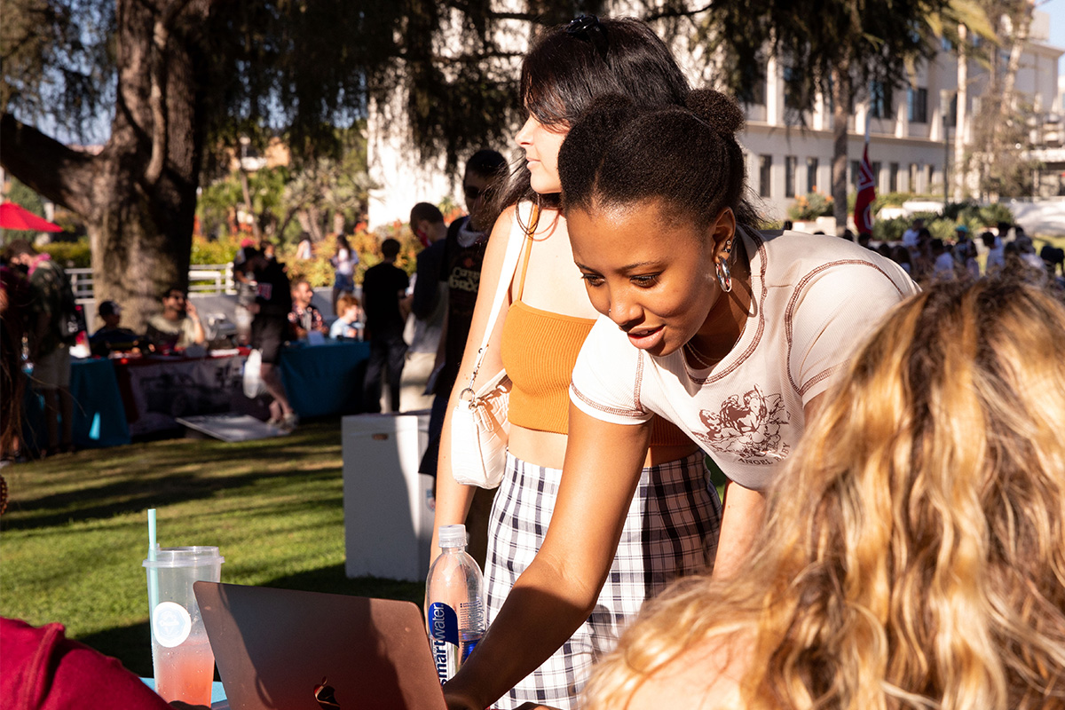 Students signing on to a computer outside at the Student Involvement Fair