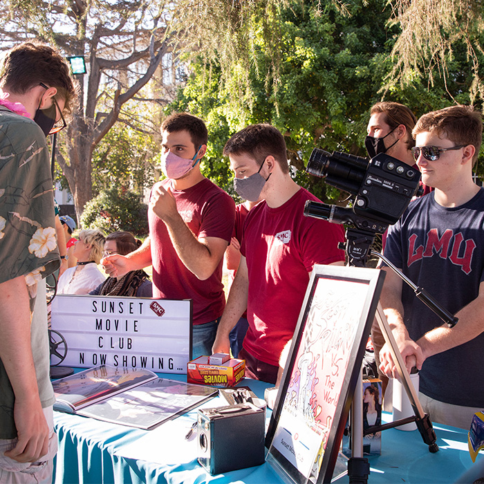 Students gathered at a table outside during the annual Involvement Fair