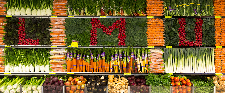 Colorful vegetables at a grocery story spelling out LMU
