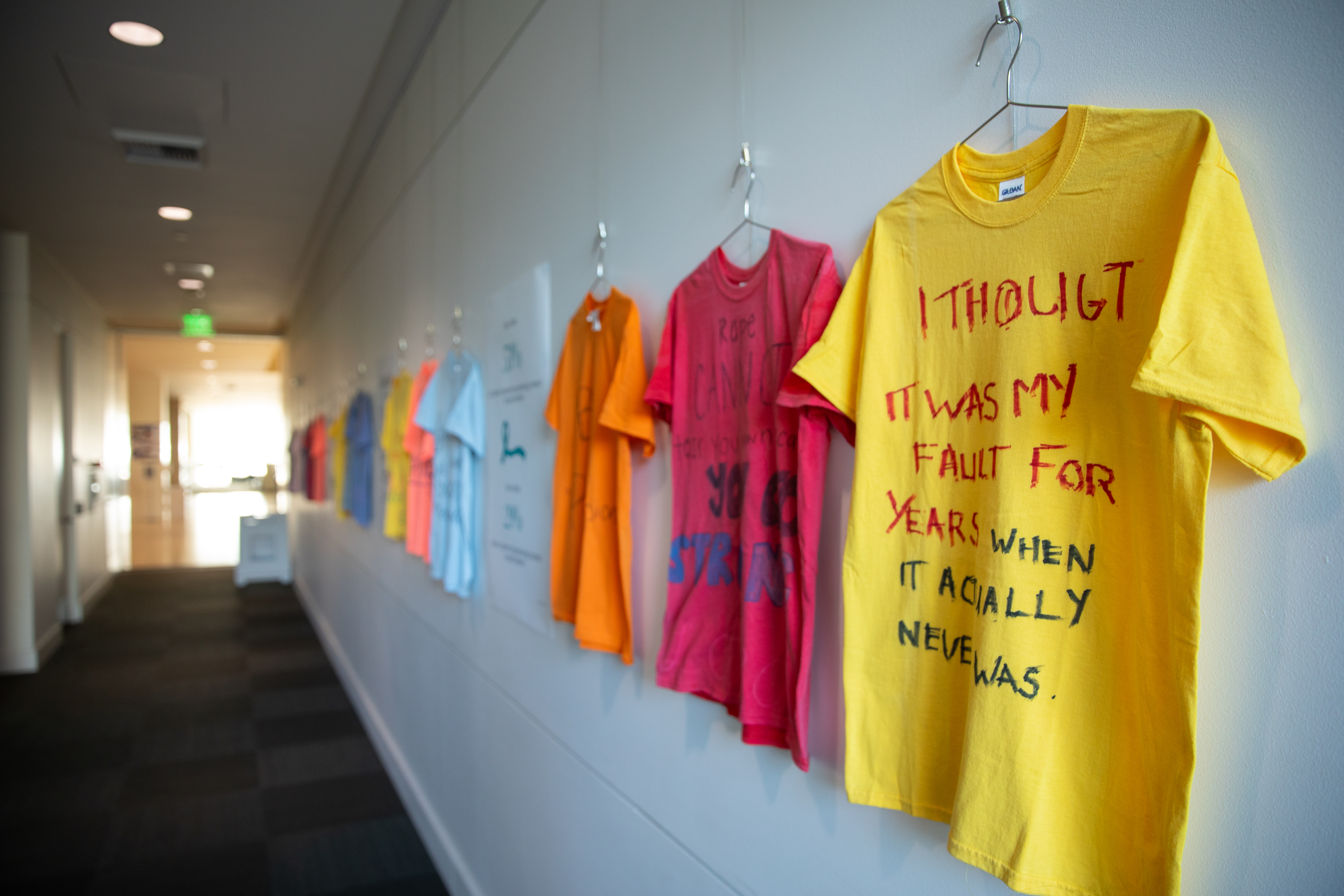 T-shirts designed by students for Sexual Assault Awareness Month hang on a clothesline.