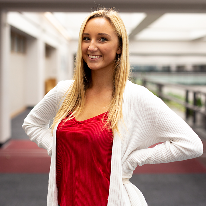 Female student standing in LMU University Hall.
