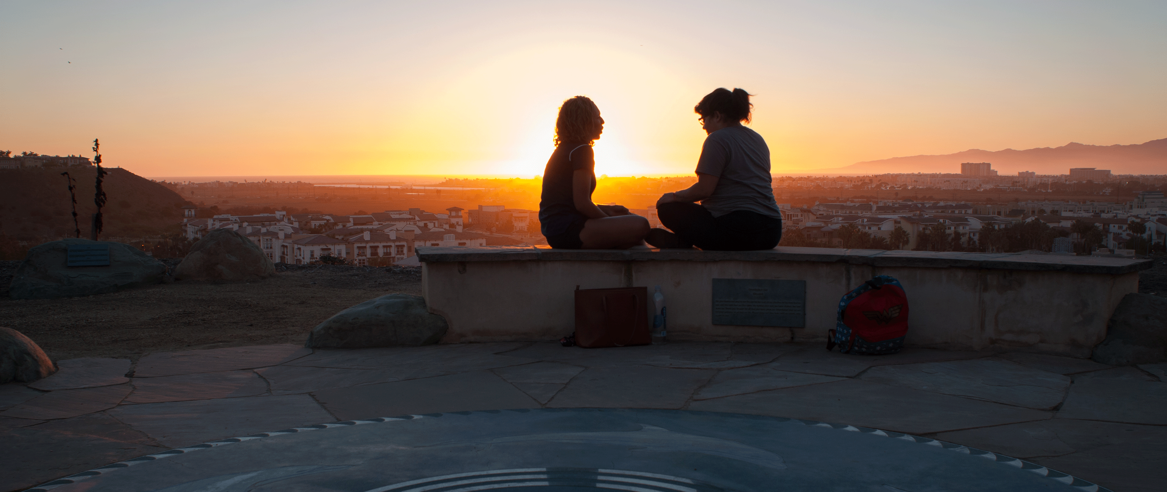 Students sitting at the memorial by the sunset