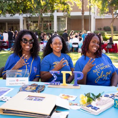 e woman smiling at the camera wearing blue shirts.