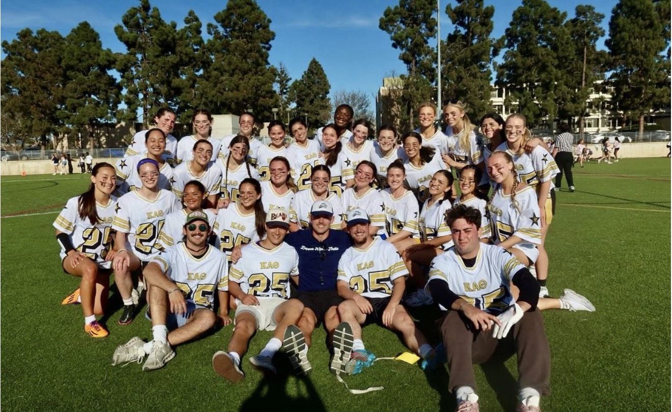 Students in flag football uniforms sitting together