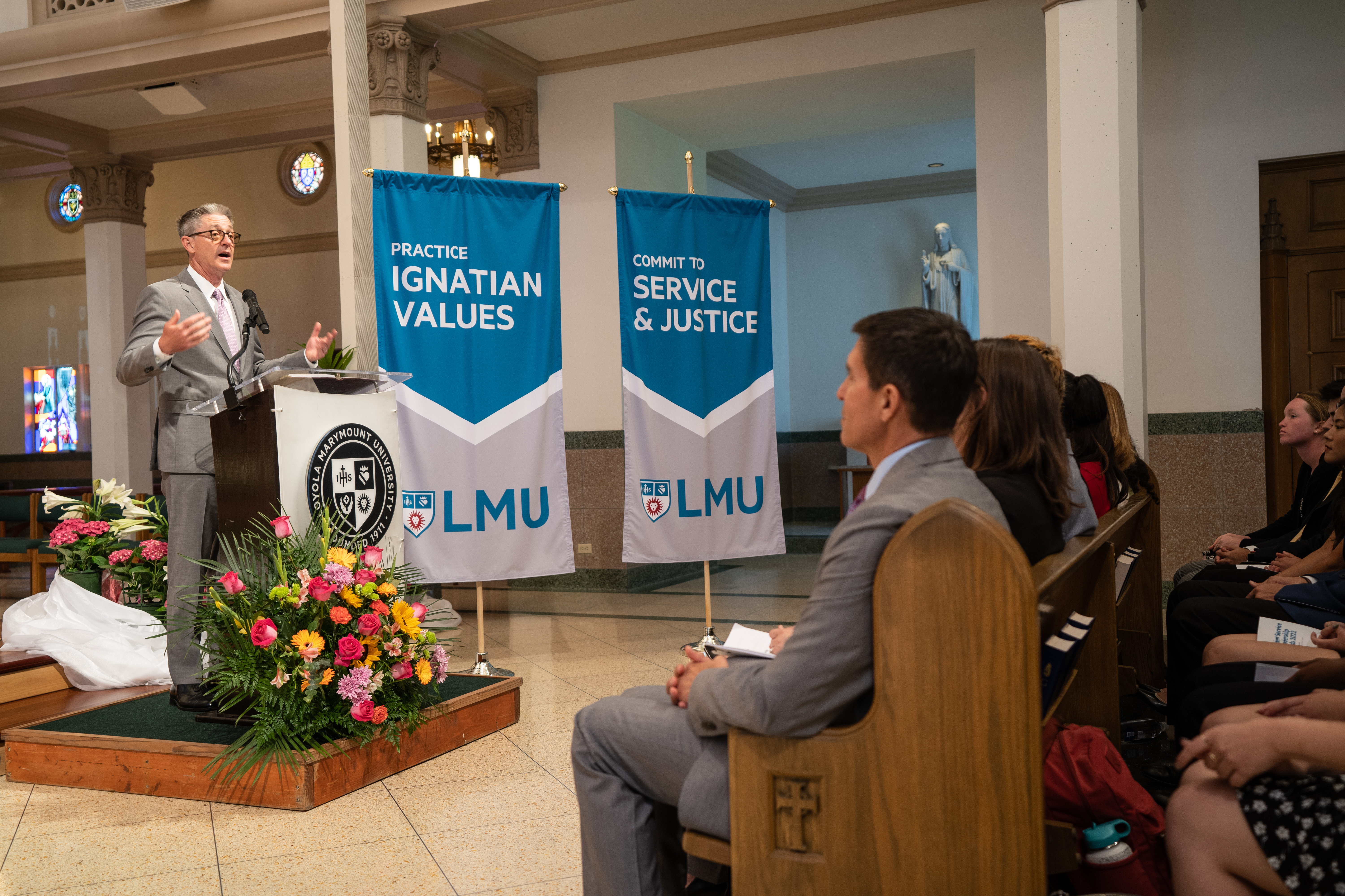 President Snyder is at the podium addressing a chapel full of people.