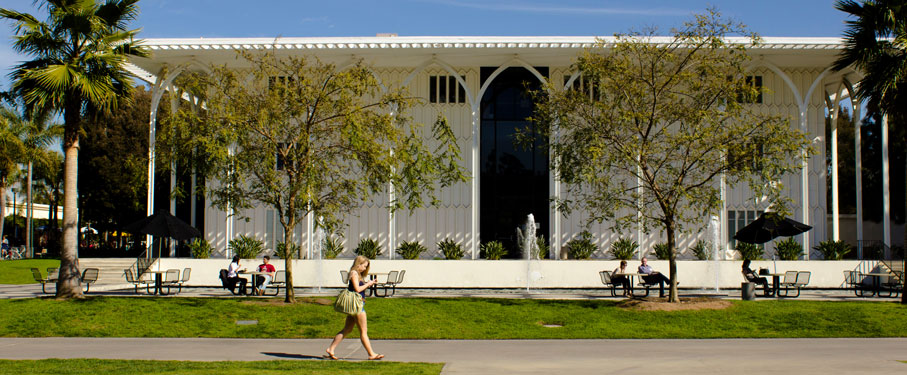 LMU students sitting and walking by the Foley building and fountain