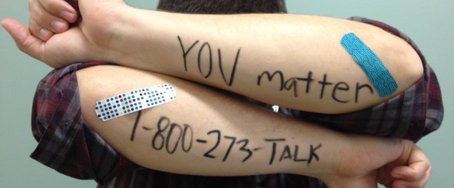 You Matter- National Suicide Hotline (800) 273-TALK writing on a man's arm