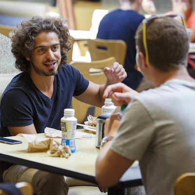 Two men talking over a meal