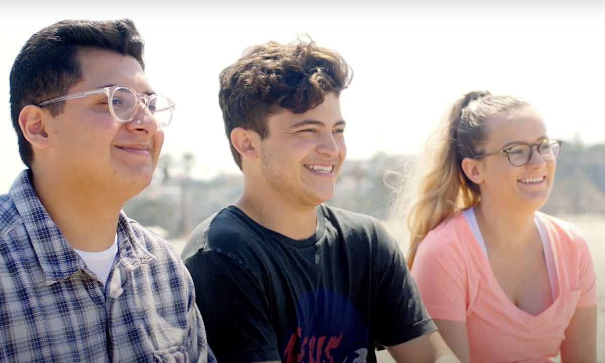 Two male and one female student smiling