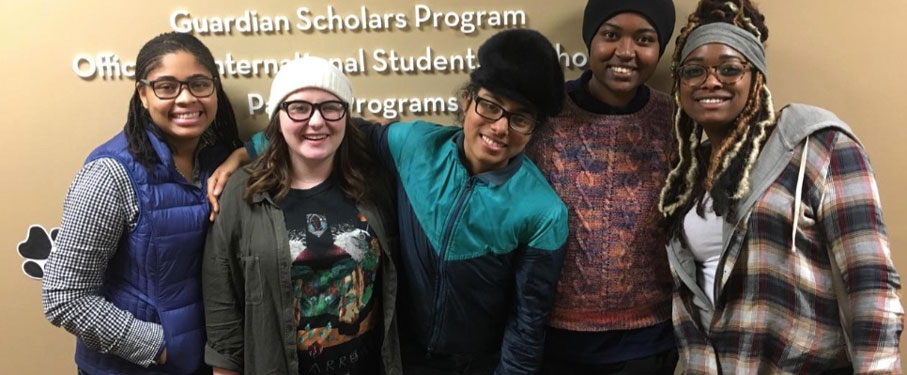 Five students smiling in the office