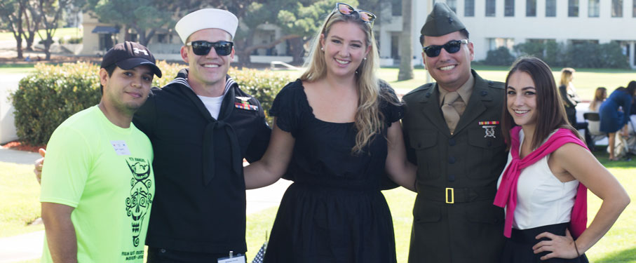 Student veterans stand outside with Veterans Program coordinator, Jamie Meugniot.